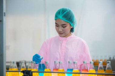 Worker Checking quality or checking stock of glass bottle in beverage factory. Worker QC working in a drink water factory 