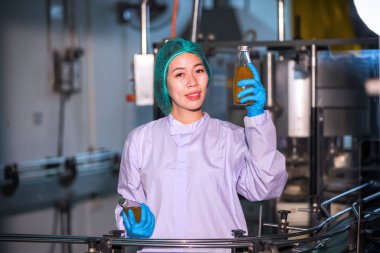 Worker Checking quality or checking stock of glass bottle in beverage factory. Worker QC working in a drink water factory 