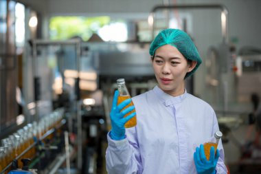 Worker Checking quality or checking stock of glass bottle in beverage factory. Worker QC working in a drink water factory 