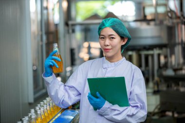 Worker Checking quality or checking stock of glass bottle in beverage factory. Worker QC working in a drink water factory 