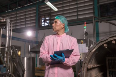 Worker Checking quality or checking stock of glass bottle in beverage factory. Worker QC working in a drink water factory 