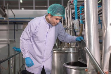 Worker Checking quality or checking stock of glass bottle in beverage factory. Worker QC working in a drink water factory 