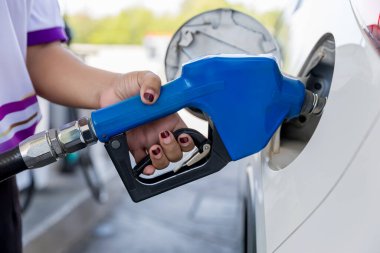 Man Refill and filling Oil Gas Fuel at station. Gas station - refueling. To fill the machine with fuel. Car fill with gasoline at a gas station. Gas station pump.	