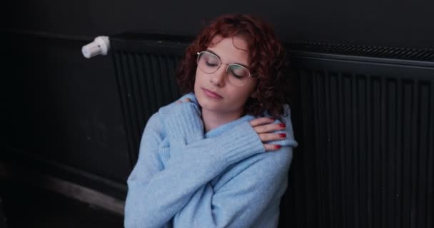 Cold Woman Thick Sweater Sits Hunched Barely Warm Radiator Winter — Stock Video