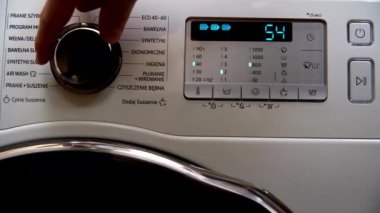 Washing delicate fabrics. Programming the washing machine. Setting temperature and number of rinses and spin speed. Modern home appliances.