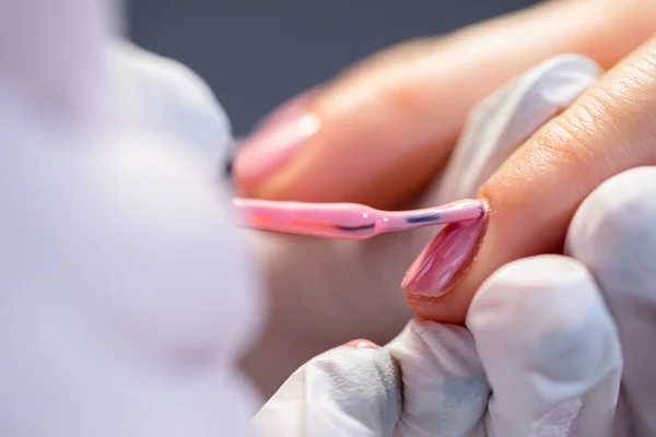 A woman using the services of a beauty salon.Preparation of the nail plate for further cosmetic procedures. Maintaining the principles of hygiene in the beauty salon. Close-up on the hands of a beauty