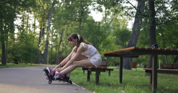 Skater Girl Wearing Rollerblades Sits Park Bench She Leans Corrects — Stock Video