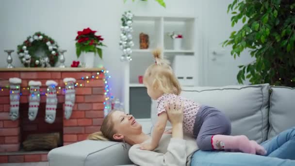 Woman Blond Hair Lies Gray Couch Holds Little Girl Her — Stock Video