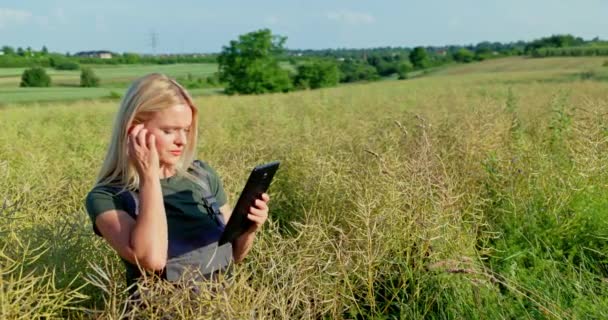 Rural Landscape Professional Female Farmer Examines Rapeseed Crops Comparing Them — Stock Video