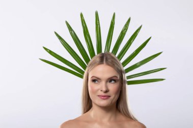 A stunning model showcases natural beauty, adorned with green leaves as a crown, exuding tranquility and charm clipart