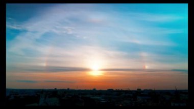 Nefes kesici ve çarpıcı bir günbatımı parlak bir şekilde gökyüzünü turuncu ve mavi renkli canlı renklerle aydınlatıyor.