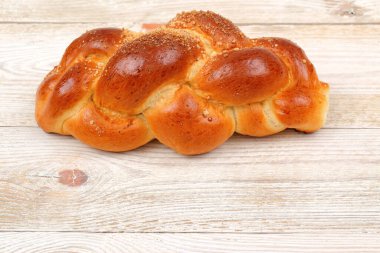 Çok güzel örülmüş bir ekmek, büyüleyici bir altın rengi kabuk sergiliyor, her bayram için mükemmel hale getiriyor.