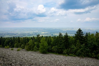 Nefes kesici bir manzara, dramatik bir gökyüzünün altındaki yemyeşil bir vadiyi gösteriyor, manzaralı bir dağdan.