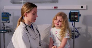 Bir hastane ortamında, şefkatli bir doktor genç bir hastayla sıcak bir şekilde iletişim kurar, güven ve rahatlığı teşvik eder.