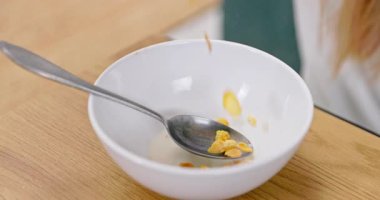 Bir kâsede mısır gevreğinin zevkini yakalamanın neşeli bir sahnesi, mükemmel bir sabah kahvaltısı anı.