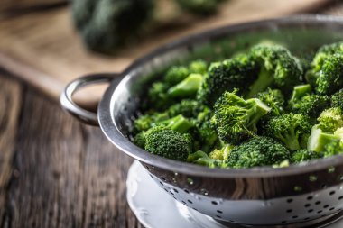 Steamed broccoli in a stainless steel steamer. Healthy vegetable concept.