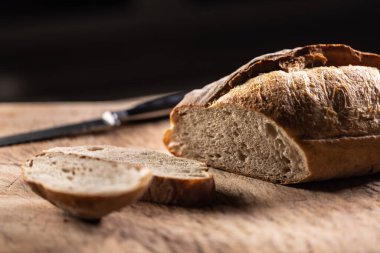 Fresh sourdough rye bread cut on a cutting board.