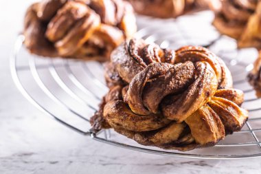 Freshly baked, caramel-cinnamon buns on the kitchen grill.