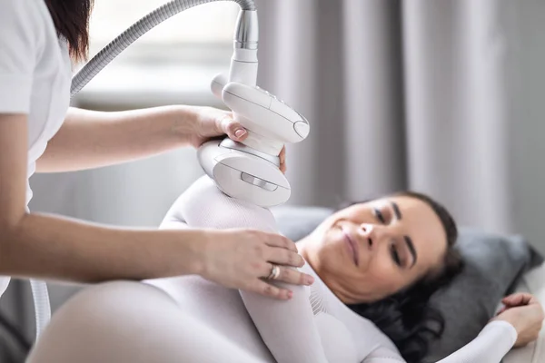 stock image Arm skincare and beautification treatment of a woman in cosmetics studio by an LPG endermology.