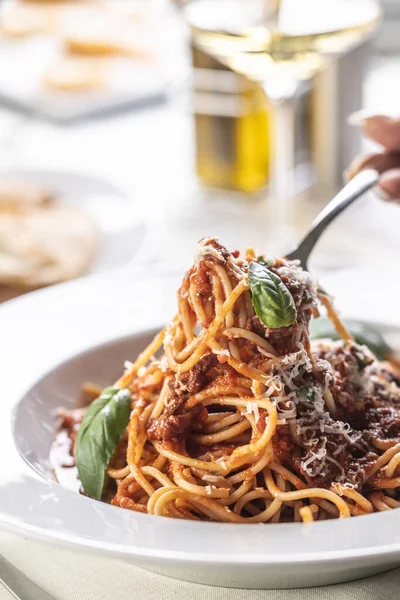 stock image Spaghetti with pomodoro sauce, basil and parmesan cheese eaten by a fork.