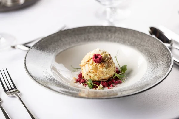 Stock image White chocolate cream with almonds and coconut served with raspberries.