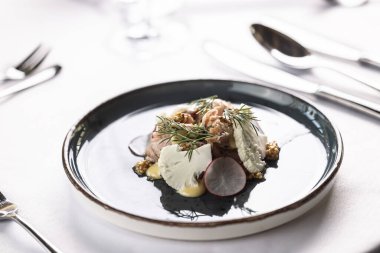 Lüks restoranda karnabahar, turp, sos ve hardal tohumlarıyla domuz eti servis edilir..