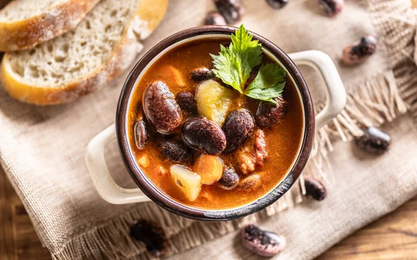 Traditional bean soup made from big beans, smoked neck, potatoes, and carrots.