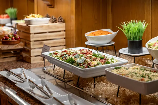Catering meals prepared for guests at a wedding or hotel dinner. Healthy salads and other vegetables.