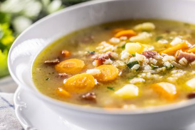 Soup made from barley groats, smoked pork neck, potatoes and root vegetables. clipart