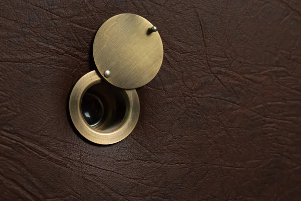 stock image Peephole with an open damper on a brown leatherette door.