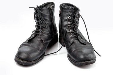 A pair of worn men's leather boots Isolated on a white background.