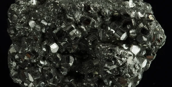 A cluster of pyrite crystals. Isolated on a black background.
