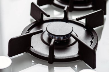 Gas burns in the white gas stove burner. Blue fire burning natural gas. Selective focus.