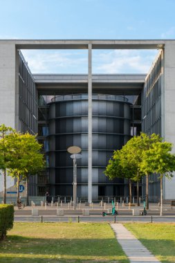 Berlin, Almanya-Ağustos 8, 2022 Paul-Lbe-Allee 'de güneşli bir günde arka planda Paul-Lbe Haus ile yürüyüş