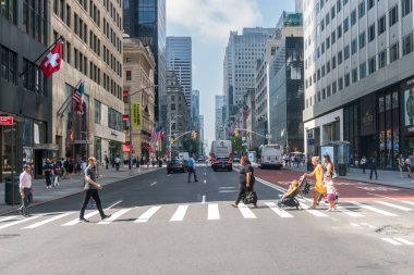 New York City, USA - August 8, 2019:people strolling among the skyscrapers in Manhattan during a sunny day