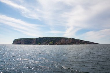 View of Bonaventure island, a protect island in the Gulf of Saint Lawrence on the tip of the Gasp Peninsula in Qubec, Canada during a sunny day