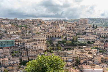 Modica, Italy-May 8, 2022:Panoramic view of the characteristic city of Modica and its cathedral of San Giorgio in Sicily during a cloudy day