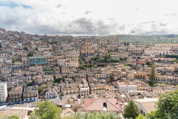 Modica, Italy-May 8, 2022:Panoramic view of the characteristic city of Modica and its cathedral of San Giorgio in Sicily during a cloudy day