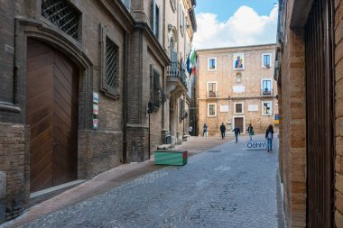 Urbino, İtalya - 27 Nisan 2019: Güneşli bir günde antik Urbino sokaklarında yürümek