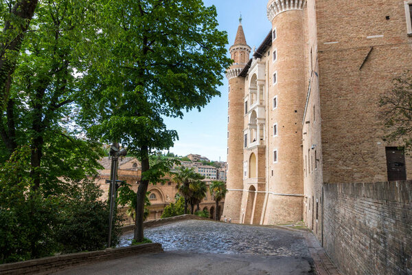 Urbino, Italy-april 27, 2019:walking through the ancient streets near the Ducal Palace of Urbino during a sunny day