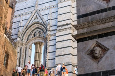 Siena, İtalya-Ağustos 10, 2020: Siena 'da bir yaz günü Katedral ile San Giovanni Battista Vaftizhanesi arasında turistler