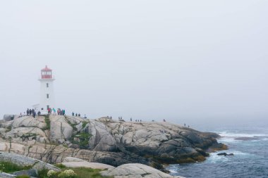 Peggy 'nin Koyu, Kanada - 13 Ağustos 2015: Sisli bir günde Nova Scotia-Kanada' daki Peggy 'nin Koyu deniz fenerinin yakınındaki insanlar