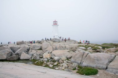 Peggy 'nin Koyu, Kanada - 13 Ağustos 2015: Sisli bir günde Nova Scotia-Kanada' daki Peggy 'nin Koyu deniz fenerinin yakınındaki insanlar