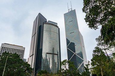 Hong Kong, 26 Mart 2019: Güneşli bir günde etrafı gökdelenlerle çevrili bir şehir parkı