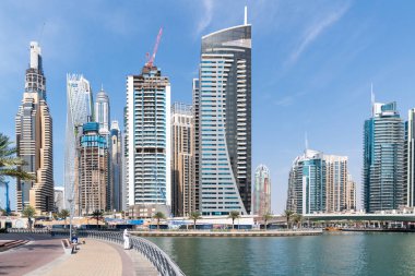 Dubai, Birleşik Arap Emirlikleri - 12 Mart 2023: Güneşli bir günde Dubai Marina 'da yürürken Dubai gökdelenlerinin manzarası