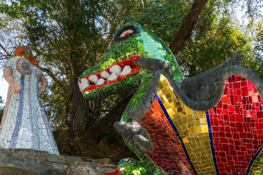 Capalbio, Italy-august 11, 2020:Visit to the colorful tarot garden of Capalbio during a sunny day. The Tarot Garden is a sculpture garden based on esoteric tarot cards, created by Niki de Saint Phalle clipart