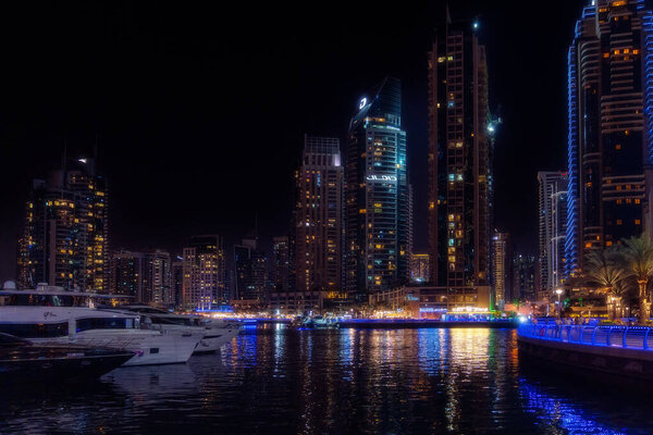 Dubai, United Arab Emirates - March 12, 2023:View of Dubai skyscrapers while walking at Dubai Marina during a night.