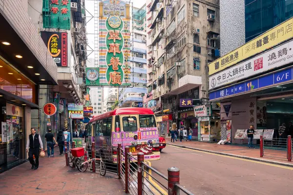 stock image Hong Kong,March 26,2019:Daily life in the streets and skyscrapers of Hong Kong during a cloudy day