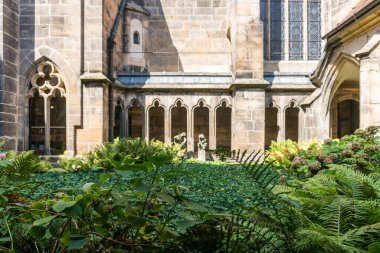 Meissen, Almanya-Ağustos 17, 2022: Güneşli bir günde Meissen Katedrali 'nin iç manastırında bahçe ve heykel