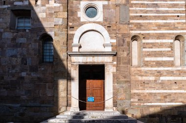 Lucca, İtalya-16 Şubat 2025: Güneşli bir günde Lucca 'daki San Frediano Bazilikası' nın yan kapısı